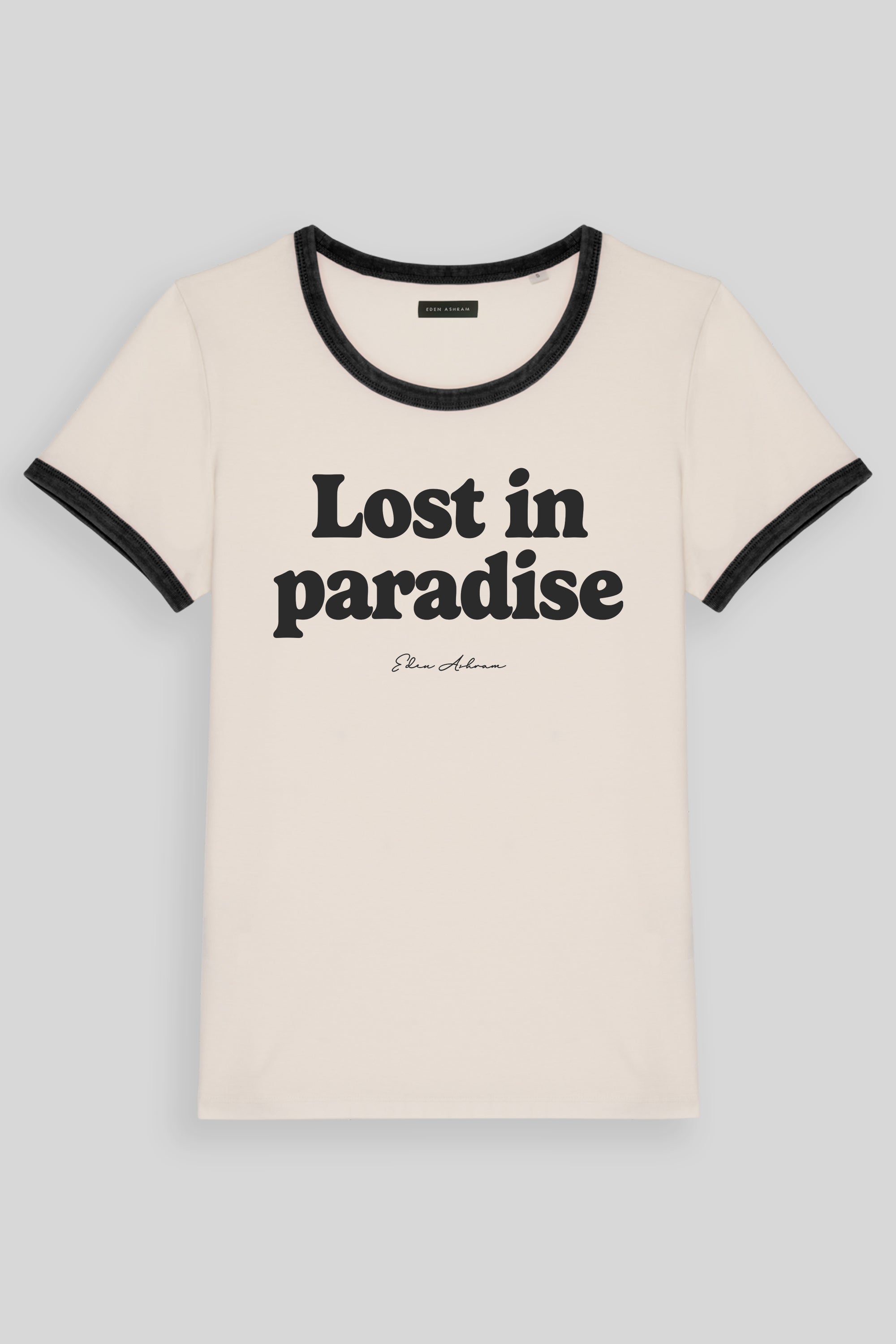 An off-white ringer t-shirt with black trim on the crew neck and sleeve cuffs, featuring the text 'Lost in paradise' and 'Sean Johnson' printed in black on the front, set against a solid gray background.