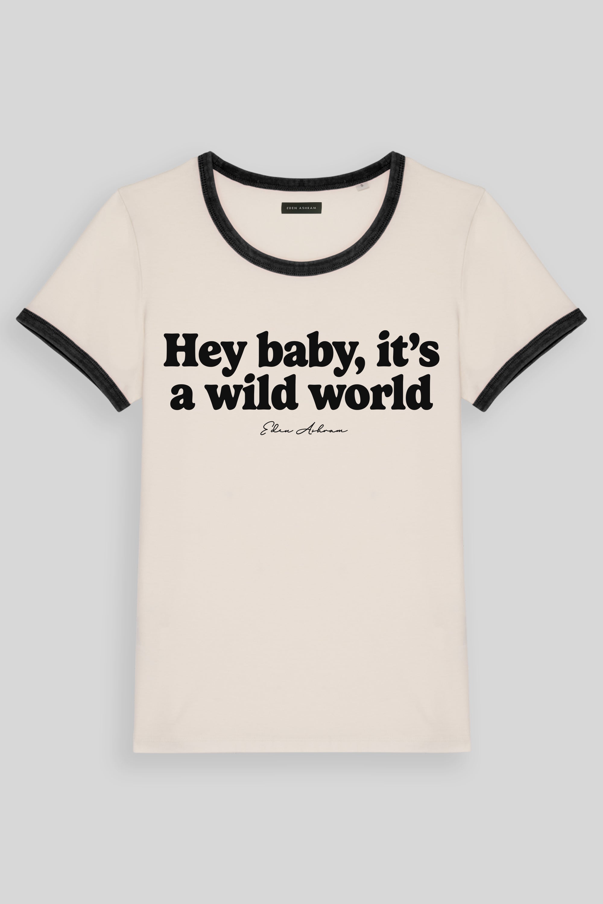 An off-white ringer t-shirt with black trim on the crew neck and sleeve cuffs, featuring the text 'Hey baby, it's a wild world'.